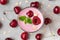 Glass of healthy cherry yogurt with fresh berries, oats and mint on white marble table. healthy breakfast