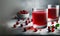 A glass of healthy cranberry juice on light gray background with cranberries and leaves