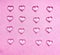 Glass hearts on pink background
