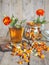 A glass of herbal tea with marigold flowers on a wooden background. Marigold tea benefits your health. Autumn medicinal background