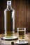 Glass of high quality distilled alcohol, called CachaÃ§a or drip in Brazil, image of rustic wood, wine cellar or rustic bar