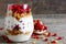 Glass of homemade yogurt parfait with granola and pomegranate fr