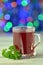 Glass of hot borsch soup on bokeh background