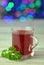 Glass of hot borsch soup on bokeh background