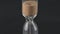 Glass hourglass, sand is poured from top to bottom. Concept: the measurement of time, the last second.