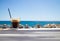 Glass with ice coffee fredo espresso or frappe on the corner of the table with beach on background