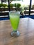 A glass of iced melon lemonade. Fresh orange juice with sweet melon syrup