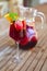 Glass of iced sangria with strawberry, orange, apple and lemon on the table