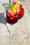 Glass of iced sangria with strawberry, orange, apple and lemon on the table