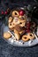 Glass jar with Christmas Linzer cookies on caramic rustic plate