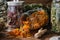 Glass jar of dry calendula flowers for making herbal tea, jars of various healthy herbs - coneflowers, linden tree blossom.