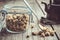 Glass jar of dry healthy chamomile buds, spoon and vintage teapot on old n wooden table.