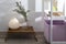 Glass jar with eucalyptus branches and a jug with limonium on a small bedside table