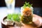 glass jar filled with olive tapenade, olive oil layer on top