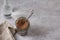 Glass jar with flax, ceramic bowl and water for soaking flax seeds on a gray textured background