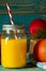 glass jar of fresh orange juice with fresh fruits on wooden table