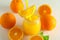 Glass jar with fresh orange juice and tubule, oranges on white background