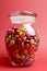 Glass Jar full of bright colorful lollies and candy with closed lid