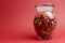 Glass Jar full of bright colorful lollies and candy with closed lid with copy space.