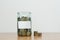 Glass jar full of coins, blank sticker, money box