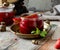 Glass jar with homemade canned strawberry jam, marmalade, jelly on rustic wooden grey table with basil