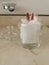 Glass jar with hygiene items in the bathroom.