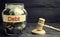 A glass jar and the inscription `debt ` and a wooden gavel. Payment of taxes and of debt to the state. Concept of financial crisis