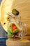 Glass jar jarcuterie nuts, olives, cheese, meat chips, salad. Healthy good carbs and fats, a light snack. Vertical photo