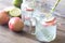 Glass jar of lime water with slices of peach