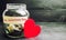 Glass jar with money and the inscription ` Valentine`s Day.` The accumulation of money for the holiday. Savings on the purchase of