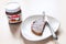 Glass jar of Nutella and toast with sweet spread