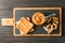 Glass jar with peanut butter and spoon, peanut, peanut butter sandwich and cutting board on wooden background