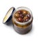 Glass jar with pitted Italian Leccino olives close up on white background