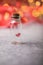 Glass jar and red heart on red background. Concept of love in Valentine`s Day