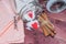 Glass jar with sugar inside decorated with Valentine\'s heart and cinnamon sticks