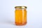 Glass jar of sunflower honey isolated