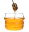 Glass jar of sunflower honey and metal dipper isolated