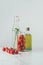 glass jar with tomatoes, glass bottle with dill and bottle of oil