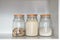 Glass jar with various product for breakfast: sugar, semolina and muesli. Food products in the kitchen storing. Horizontal