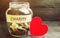 Glass jar with the words Charity and the heart. The concept of accumulating money for donations. Saving. Social medical help from