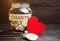 Glass jar with the words Charity and the heart. The concept of accumulating money for donations. Saving. Social medical help from