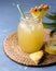 Glass Jarr of Tasty and Cold Pineapple Juice Diet Healthy Beverage Detox Juice Blue Background Above Ripe Pineapple