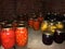 Glass jars with cucumbers, tomatoes and jam in the cellar