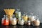 Glass jars with different types of groats and pasta on table