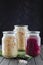 Glass jars of fermented white, red cabbage, spices, salt. vegetables on a dark background. using textile green. fermentation is a