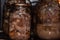 Glass jars with a stewed pork in hot oven. Homemade cooking with a traditional recipe, Ukrainian cuisine