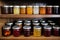 glass jars of various homemade jams on a pantry shelf