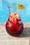 Glass jug of iced sangria with strawberry, orange, apple and lemon