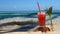 Glass of juice on a coconut on the sea beach