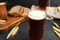 Glass of kvass, bread and spikes on black table